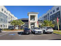 Modern apartment building with ample parking and landscaped grounds at 1210 Southstation Pl # 303, Orlando, FL 32809