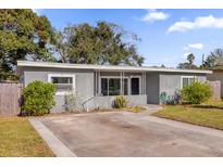 Charming single story home featuring a spacious front yard with tidy landscaping and a concrete driveway at 4535 Arch St, Orlando, FL 32808