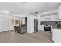 Modern kitchen with white cabinets and granite countertops at 4535 Arch St, Orlando, FL 32808
