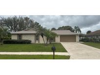Charming single-story home featuring a well-maintained lawn, mature landscaping, and a long private driveway at 2158 Sussex Rd, Winter Park, FL 32792