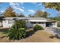 Ranch style home with carport and landscaping at 12 Seminole Dr, Debary, FL 32713