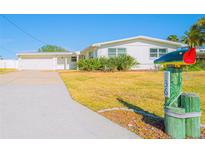 Charming single-story home featuring a well-manicured lawn and a unique fish mailbox at 136 Reef Rd, South Daytona, FL 32119