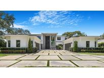 Stunning modern home featuring a grand entrance and meticulously landscaped front yard with paver driveway at 2161 Sharon Rd, Winter Park, FL 32789