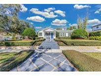 White house with blue door, manicured hedges, and a stone walkway at 1001 Nottingham St, Orlando, FL 32803