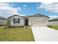 Charming single-story home featuring a two-car garage and well-maintained front yard at 1341 Oak Valley Dr, Auburndale, FL 33823