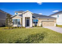 Two-story house with stone accents and a 2-car garage at 686 Creeping Fig St, Apopka, FL 32703