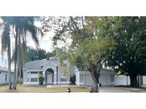 Charming two-story home with well-maintained landscaping and mature trees, creating an inviting curb appeal at 2708 Smithfield Dr, Orlando, FL 32837