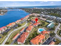 Scenic aerial view of community with a pool, waterfront access, and meticulously kept grounds at 445 Bouchelle Dr # 202, New Smyrna Beach, FL 32169