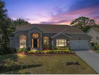 Charming single-story home with brick accents, manicured lawn, and a well-lit entrance, perfect for a welcoming curb appeal at 2226 Lake Marion Dr, Apopka, FL 32712