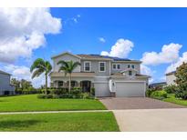 Two-story house with solar panels, landscaped yard, and a paved driveway at 4150 Sunset Preserve Blvd, Orlando, FL 32820