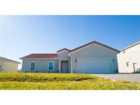 New single-story home with attached garage and red tile roof at 459 Cinnamon Dr, Kissimmee, FL 34759