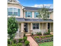 Attractive townhome with a landscaped front yard and a brick walkway at 8622 Dufferin Ln, Orlando, FL 32832