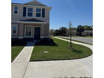 Traditional two-story home featuring a neatly manicured lawn and inviting entryway at 6094 Galloping Dr, Apopka, FL 32712