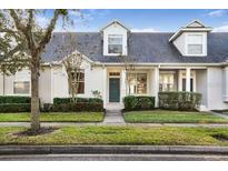 Charming two-story home with a welcoming front porch and landscaping at 14480 Chinese Elm Dr, Orlando, FL 32828