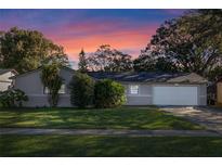 Charming single-story home with a well-maintained lawn and attached garage at 5533 Satel Dr, Orlando, FL 32810