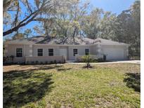 Charming single-story home featuring a well-manicured lawn and an attached two-car garage at 632 Oakhurst St, Altamonte Springs, FL 32701