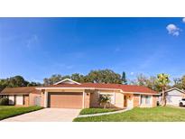 Charming single-story home with a spacious garage, well-manicured lawn, and beautiful landscaping at 1859 Lake Hill Cir, Orlando, FL 32818
