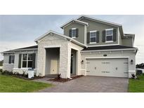 Charming two-story home featuring a stone facade, two-car garage and well maintained landscaping at 987 Hawksnest Pt, Oviedo, FL 32765