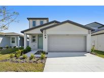 Charming two-story home featuring a two-car garage and manicured landscaping at 2735 Virginia Pine Dr, Bartow, FL 33830