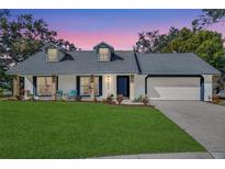 Charming single-story home featuring a well-manicured lawn and a classic brick-accented facade at 4034 Winderlakes Dr, Orlando, FL 32835