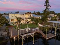 Stunning waterfront home features a private dock, pool, outdoor kitchen, and lush landscaping at 25 Cunningham Dr, New Smyrna Beach, FL 32168
