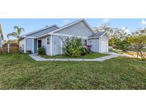 Cute blue house with a well-maintained lawn and a white picket fence at 250 Silas Phelps Ct, Orlando, FL 32828