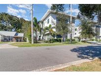 Modern 2-story building with gray and white exterior, landscaping, and sidewalk at 2902 Sylvan Ave, Orlando, FL 32806