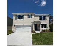 Charming two-story home featuring a manicured lawn, two car garage, and lovely dark green shutters at 3541 Sandalwood Isle Way, Ocoee, FL 34761