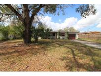 Charming single-story home with a mature tree and driveway at 1040 Santa Anita St, Orlando, FL 32808