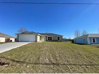 Newly constructed one-story home with a spacious front yard and attached garage at 199 Juniper Way, Ocala, FL 34472