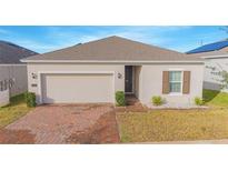 Charming single-story home featuring a brick driveway, attached garage, and well-maintained front yard at 473 Disa Dr, Davenport, FL 33837