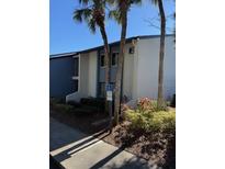 Condo building exterior, featuring landscaping and parking at 2 Escondido Cir # 189, Altamonte Springs, FL 32701