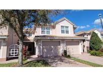 Charming townhome featuring a private garage and a meticulously maintained landscaped yard, offering curb appeal and convenience at 8343 Bella Tierra Ct # 8343, Davenport, FL 33896