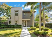 Modern two-story home with landscaped lawn and palm trees at 1970 Laurel Rd, Winter Park, FL 32789