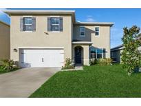 Two-story house with a two-car garage and well-maintained lawn at 3282 Eastgrove Ter, Sanford, FL 32771