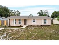 Newly renovated single-story home with a charming front porch and landscaped yard at 1209 Baranova Rd, Ocoee, FL 34761