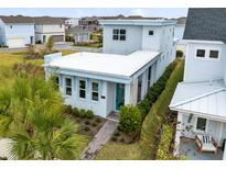 Modern two-story home with a light blue exterior and teal front door at 13104 Markowitz Aly, Orlando, FL 32827