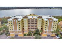 Beautiful waterfront condominium featuring a large building with lovely landscaping at 6336 Buford St # 705, Orlando, FL 32835