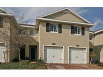Two-story townhome with two-car garage and brick driveway at 10763 Regent Square Dr # 1903, Orlando, FL 32825