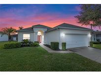 One-story house with a two-car garage, landscaped lawn, and a charming front entrance at 401 Montara Dr, Davenport, FL 33897