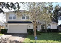 Two-story house with attached garage and well-maintained lawn at 1730 Tealbriar Ave, Oviedo, FL 32765