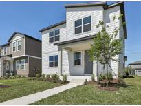 Charming two-story home with white siding, a manicured lawn, and a welcoming front porch at 2378 Broadbrook Dr, St Cloud, FL 34771