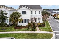 Two-story house with white exterior, black shutters, and a landscaped lawn at 9133 Smithies St, Orlando, FL 32827