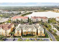 A scenic aerial view of the condo community with lush landscaping and a beautiful lake nearby at 4814 Cayview Ave # 40613, Orlando, FL 32819