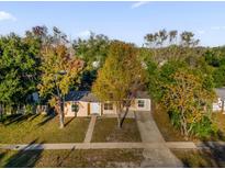 Charming single-story home with a well-maintained yard and mature trees at 2341 Hadley St, Deltona, FL 32738