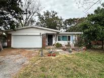 Ranch-style home with a white garage door and a spacious yard at 505 Lake Shore Dr, Maitland, FL 32751