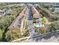 Attractive townhome community features a community pool, lush landscaping, and convenient parking at 607 Pensacola Ln, Lake Mary, FL 32746
