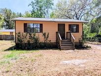 Charming single-story home with a quaint front porch and well-maintained yard at 19942 Se 155Th Pl, Umatilla, FL 32784