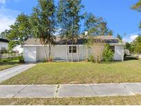 Charming single-story home with a well-maintained lawn and mature trees providing shade at 514 S 7Th St, Lake Wales, FL 33853