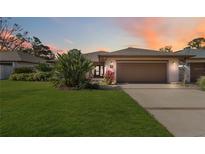 Inviting home exterior with landscaped lawn and attached garage at 7 Huntley Ct., Haines City, FL 33844